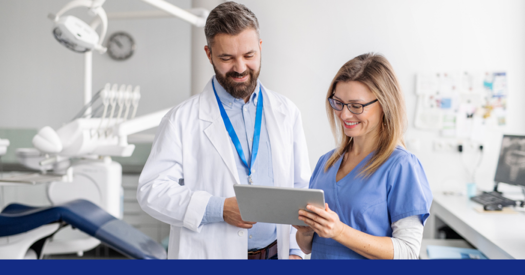 Dental staff and a doctor looking at the patient's data