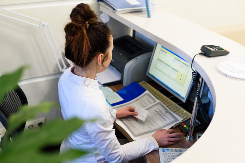 female receptionist overwhelmed with work